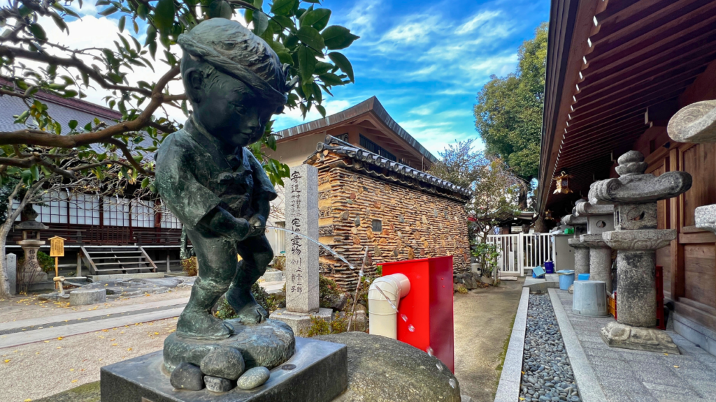 Statue of a little boy at Kushida Shrine