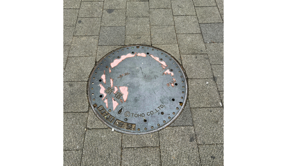 A Godzilla manhole cover